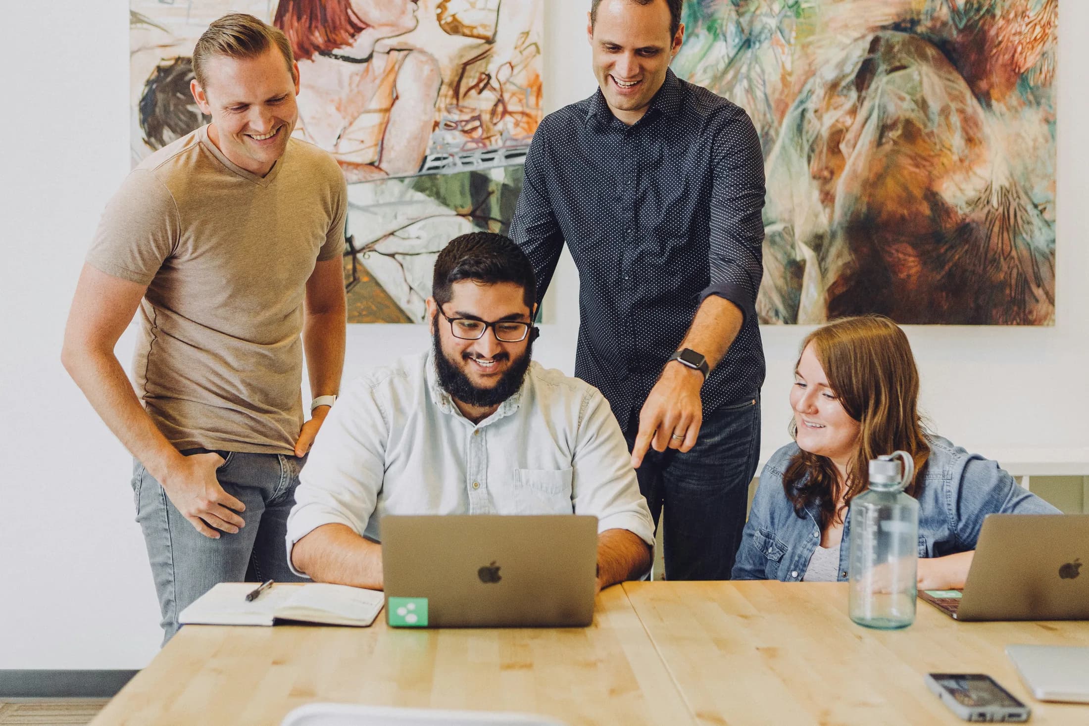 People reviewing work on a laptop